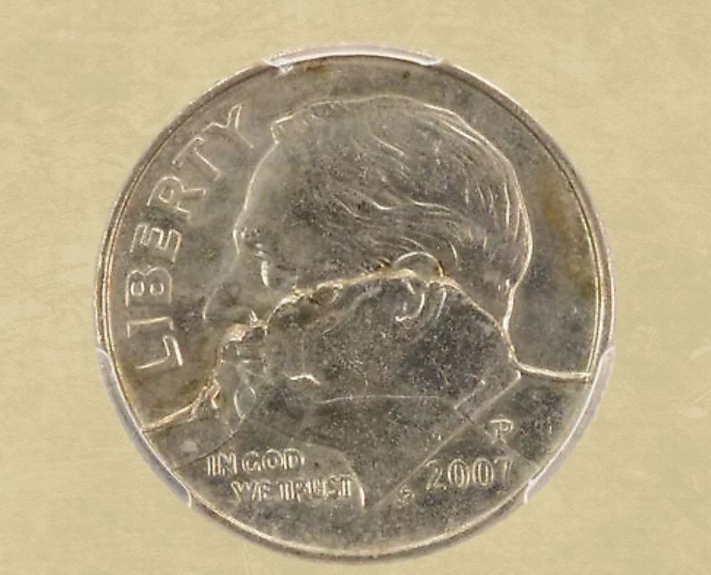 2007 Roosevelt dime rim cud error showing raised blob of metal at the coin rim where a die piece broke away